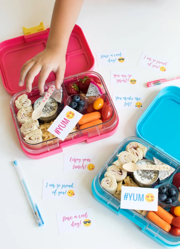 Various emoji lunchbox notes on a table