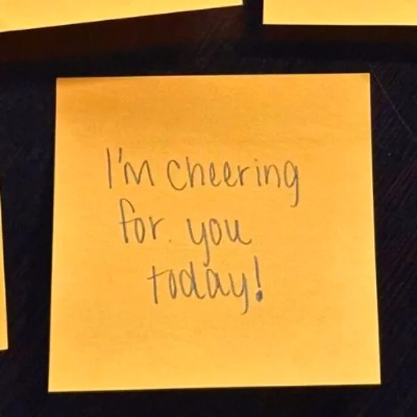 A small, heartfelt note tucked discreetly into a child's lunchbox, symbolizing loving connection.