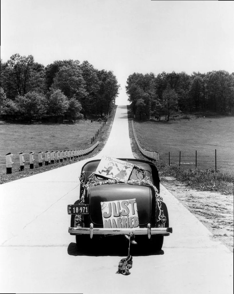 A vintage car with a 'Just Married' sign, representing the start of a couple's new journey.