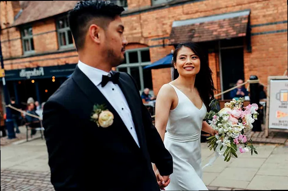 A romantic city wedding photo of a happy couple, ideal for a friend's celebratory post.