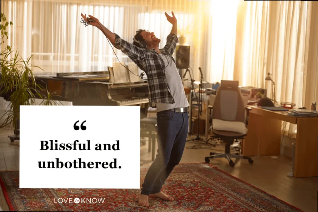 Man dancing with headphones on, embodying relaxed confidence and an unbothered attitude.