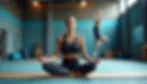 Woman meditating on a yoga mat in a gym, symbolizing mental resilience and focus.