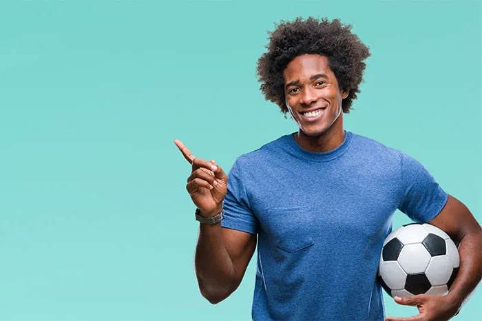 A parent looking at a phone with a text message about a sports event, illustrating communication with guardians.