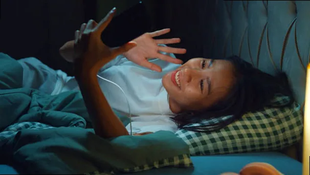 A romantic image of a couple silhouetted against a moonlit sky, holding hands.