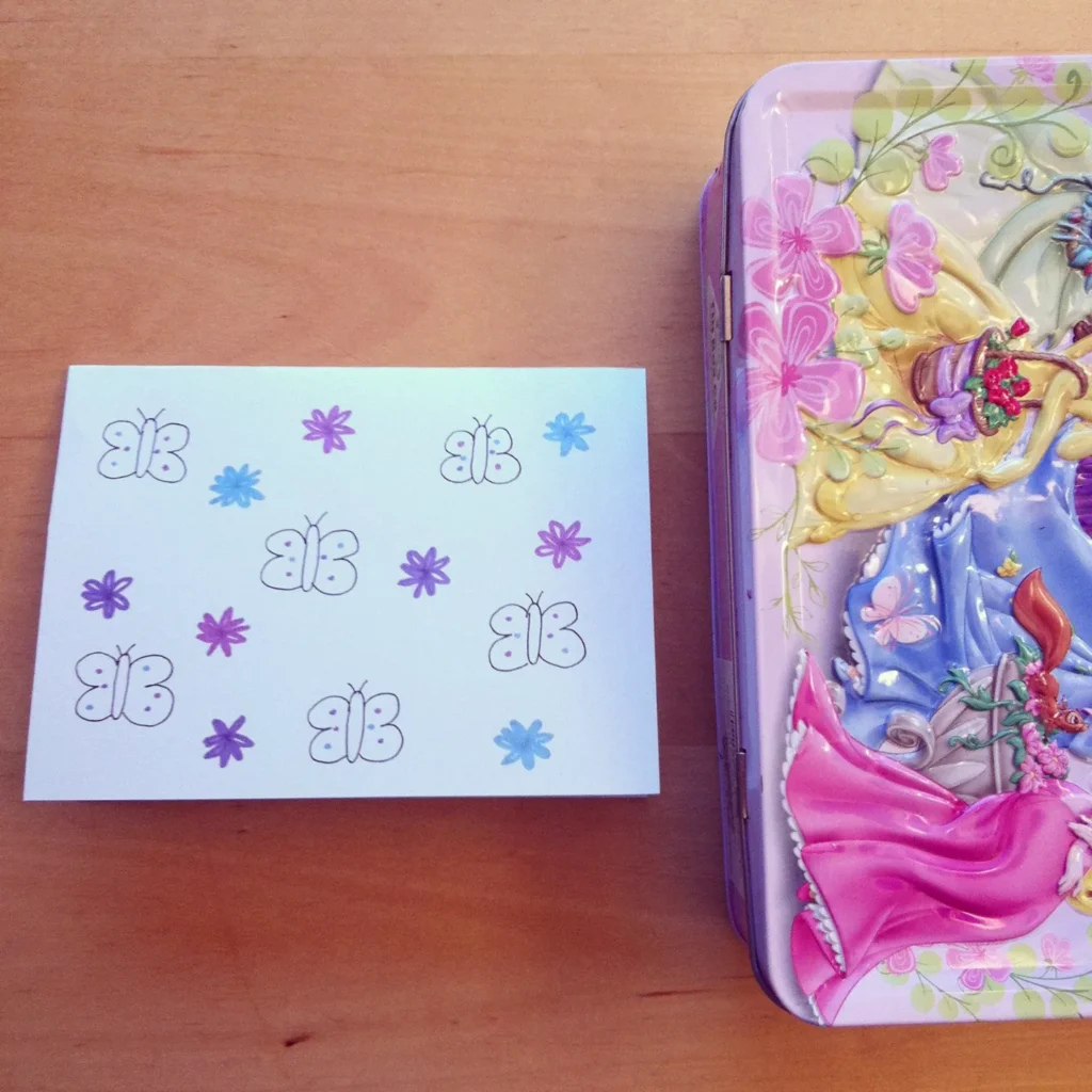 A close-up of several handmade lunchbox love notes with simple drawings and messages, showing a personal touch.