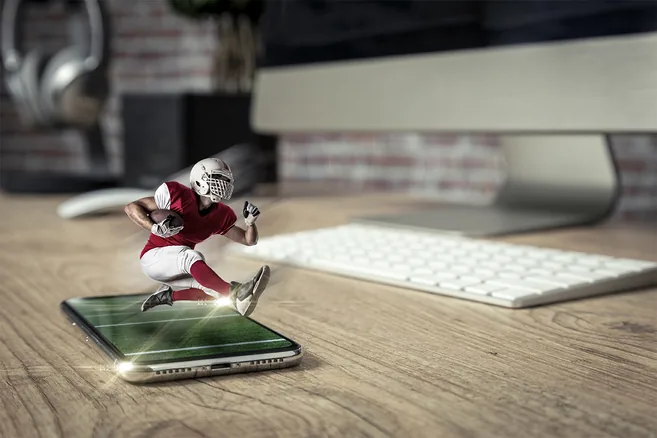 A diverse sports team huddling together, hands stacked, showing unity and determination before a game.