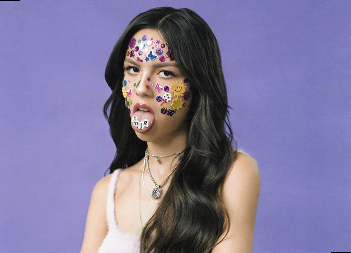 Olivia sticking her tongue out with stickers on her face