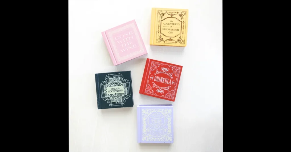 Clear book-shaped vase labeled Jane Eyre holding pink and white peonies beside stacked books, adding a literary statement to decor.