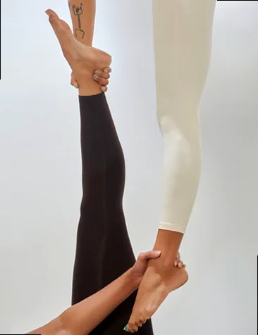 A person gracefully suspended in an aerial yoga hammock, showcasing strength and flexibility.