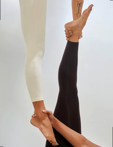 An aerial yoga practitioner suspended gracefully in a hammock, showcasing strength and artistry.