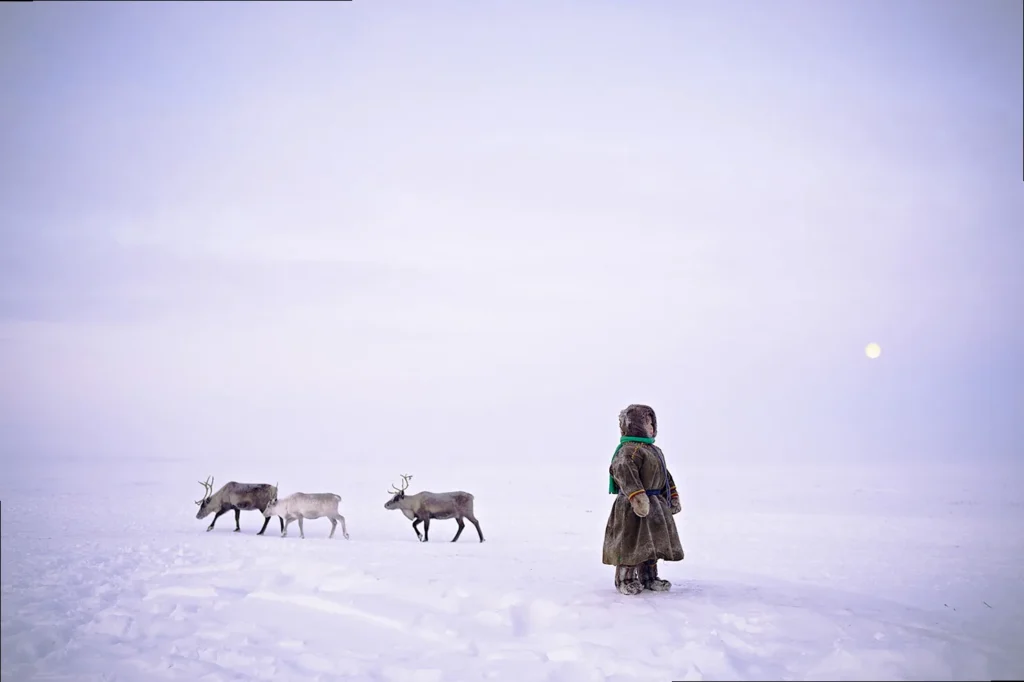 A stark black and white image of a lone figure under a vast night sky, emphasizing abstract forms and emotional depth.