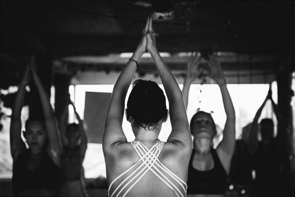 A serene yoga practitioner in a natural setting, embodying peace and strong brand presence.