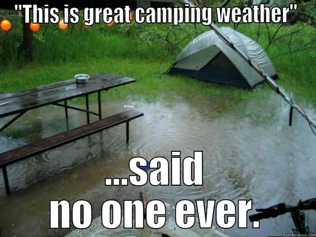 Flooded campsite with a tent and picnic table in heavy rain, humorously showing a camping mishap