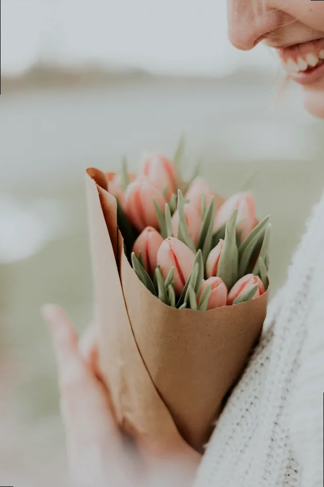 A bouquet of tulips wrapped in brown paper, symbolizing a simple yet heartfelt gesture for a busy mom.