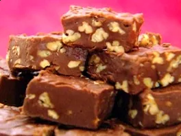 Delicious homemade nutty fudge squares with visible nuts, ready for indulgence