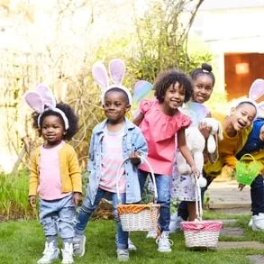 Children playing with Easter baskets in a vibrant spring garden