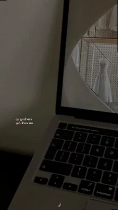 A minimalist work-from-home setup with a laptop on a clean desk next to a window and a small plant, conveying calm productivity.