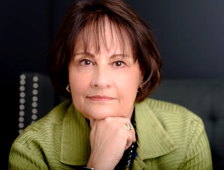 A person writing in a journal with a pen, surrounded by warm, soft light, representing personal gratitude practices.