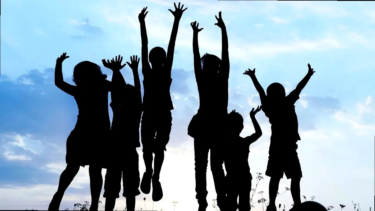 Children laughing and playing joyfully, celebrating Children's Day with boundless energy and happy spirits.