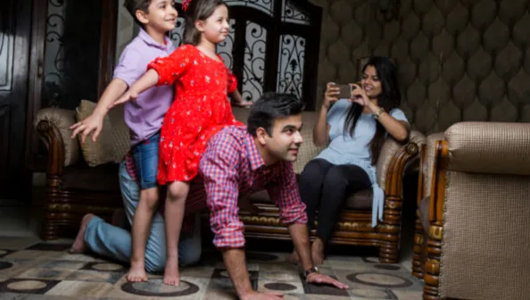 Parents and children laughing together, symbolizing happiness on Parents Day.