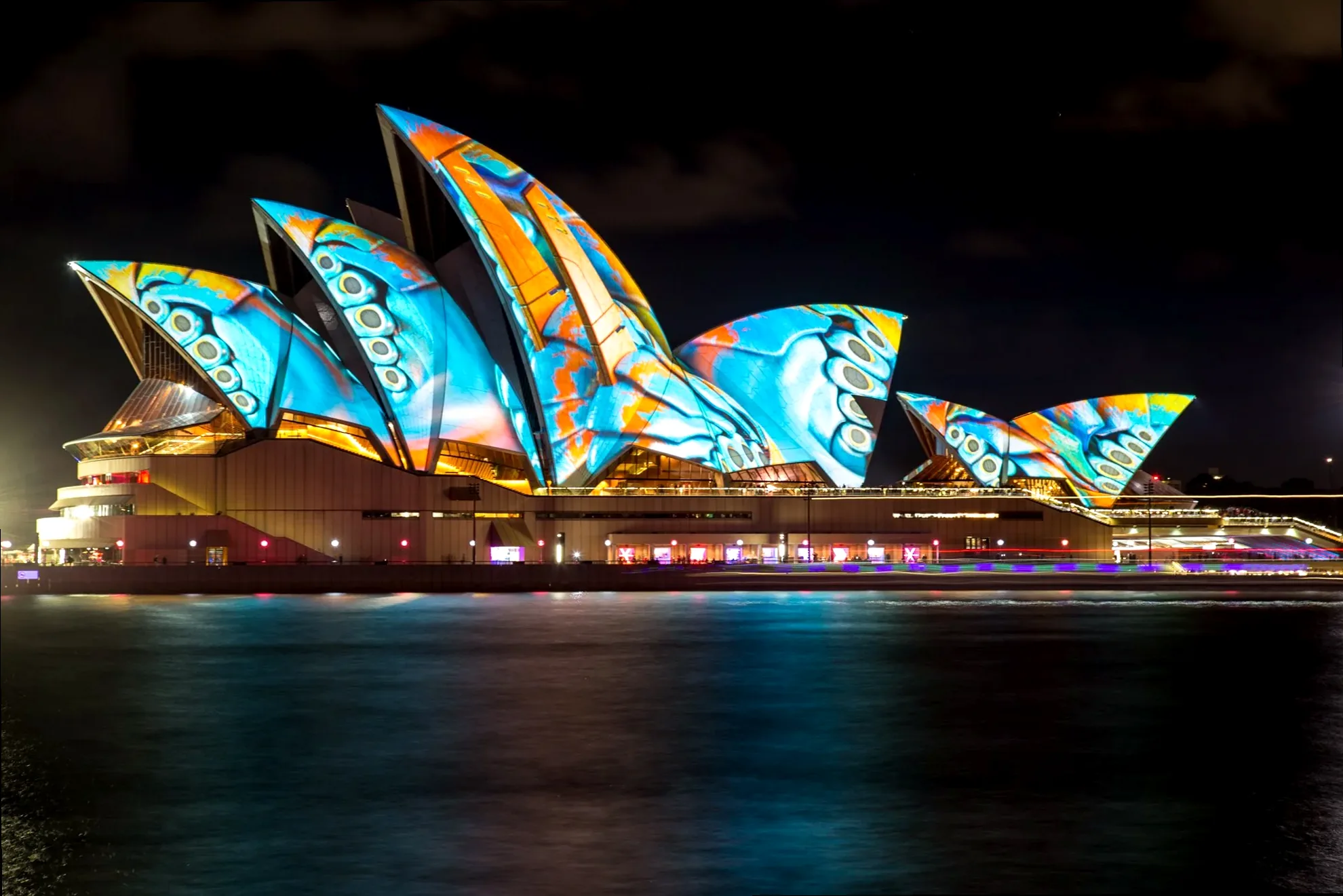 The Sydney Opera House sails illuminated with vibrant, abstract projections during Vivid Sydney.