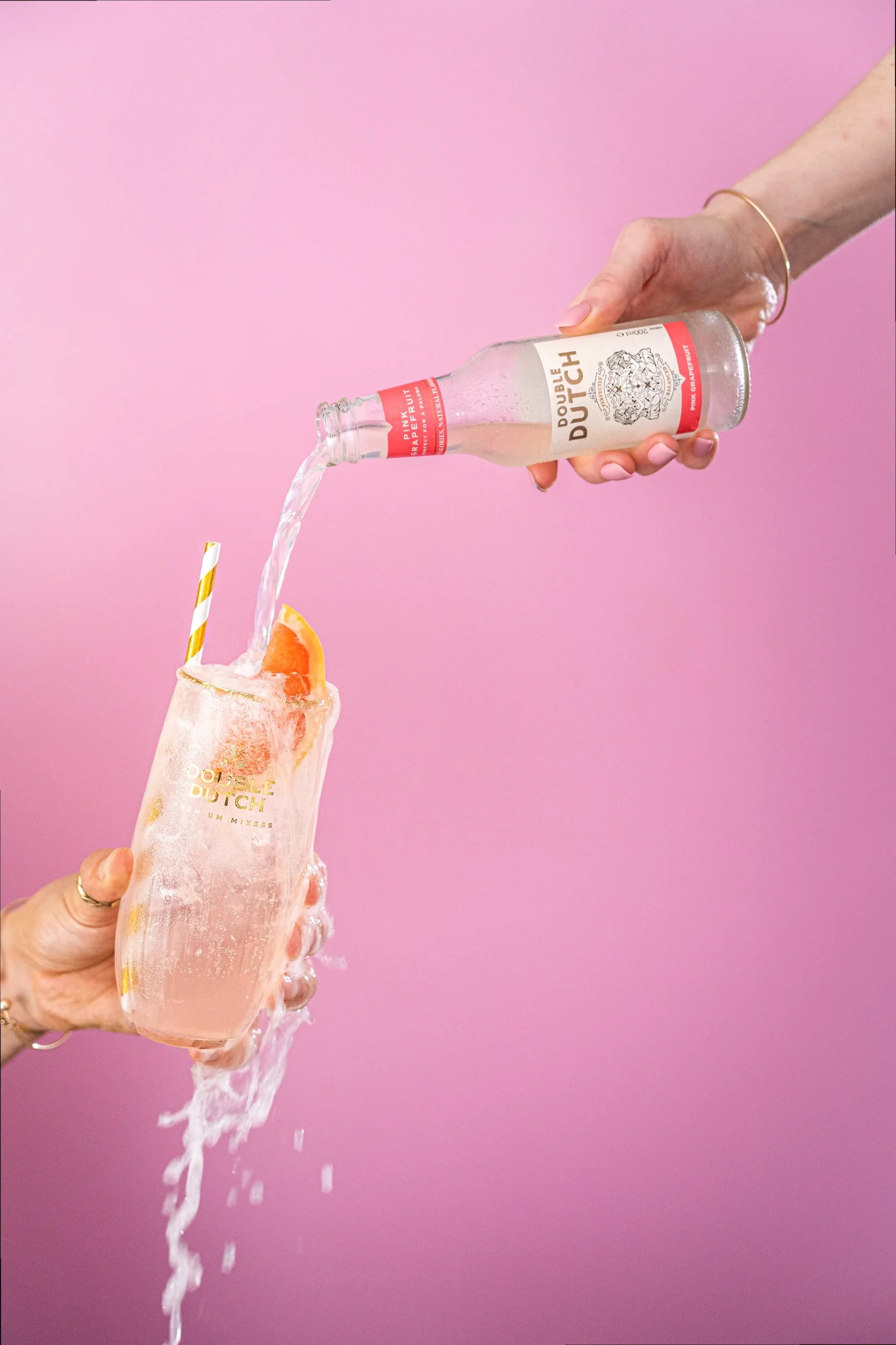 A perfectly crafted Paloma cocktail in a tall glass, garnished with a pink grapefruit slice and a salted rim, against a bright, refreshing background.
