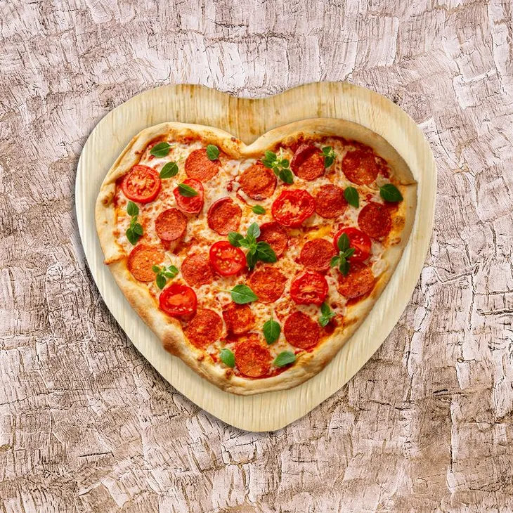 Friends enjoying a vibrant pizza party with various pizza types and drinks, celebrating National Pizza Party Day with laughter and shared slices.